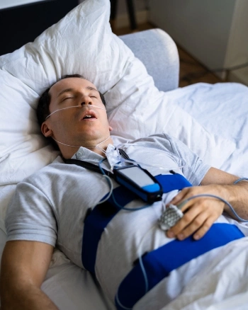 Man sleeping with sleep monitoring equipment