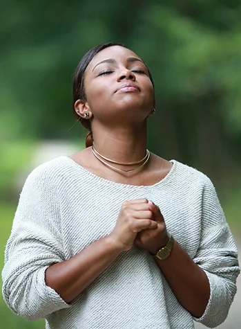 Hopeful woman taking deep breath