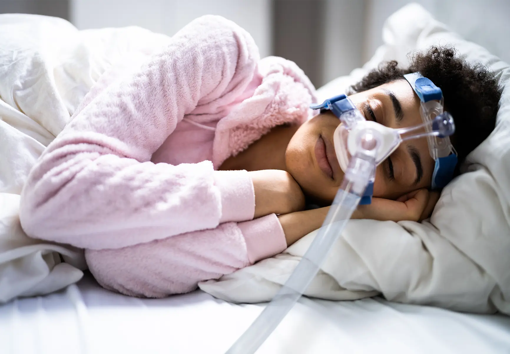 Woman sleeping with CPAP machine