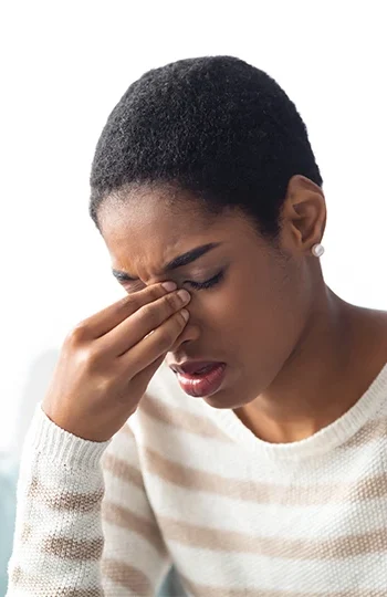 Black woman holding her sinuses