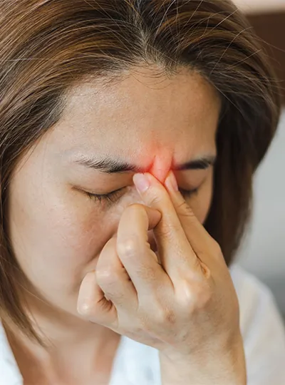 Woman holding her sinuses in pain