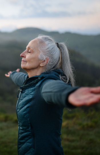 woman taking a deep breath outside