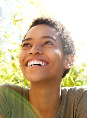 Black woman smiling in the sunshine