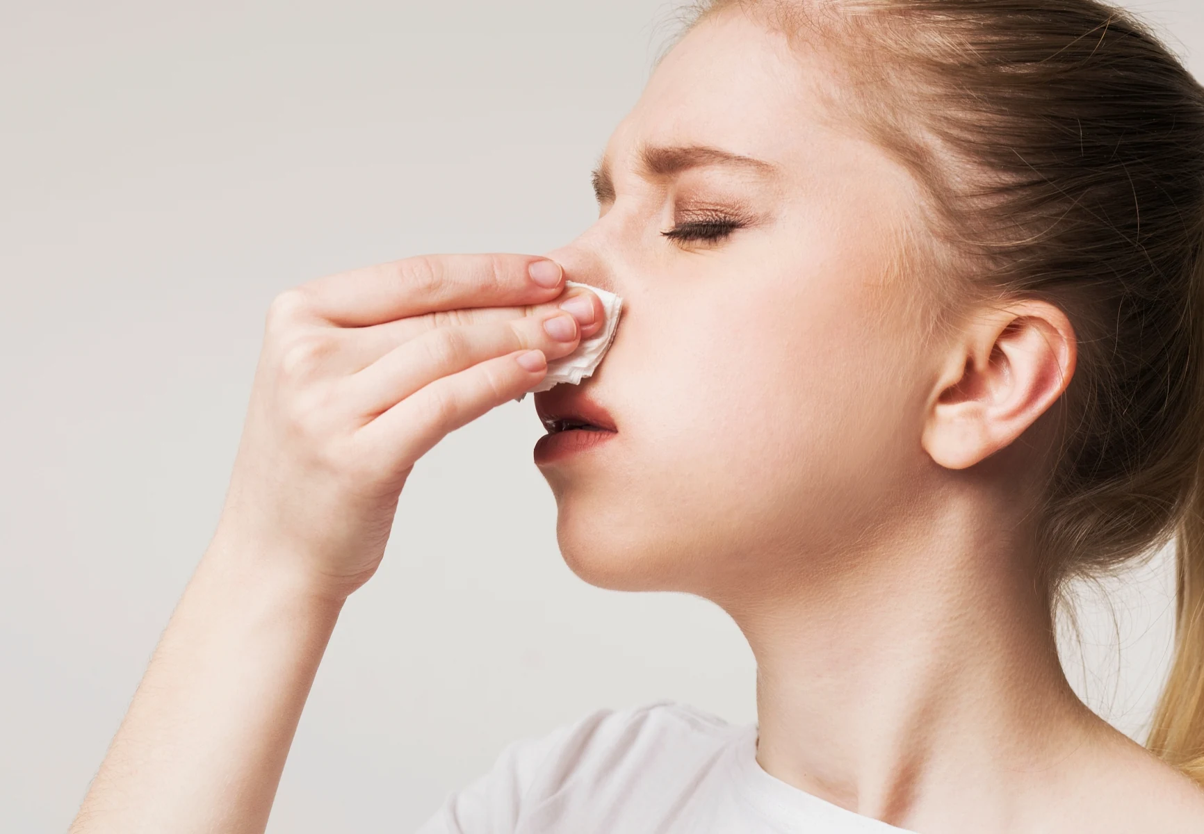 Woman blowing her nose