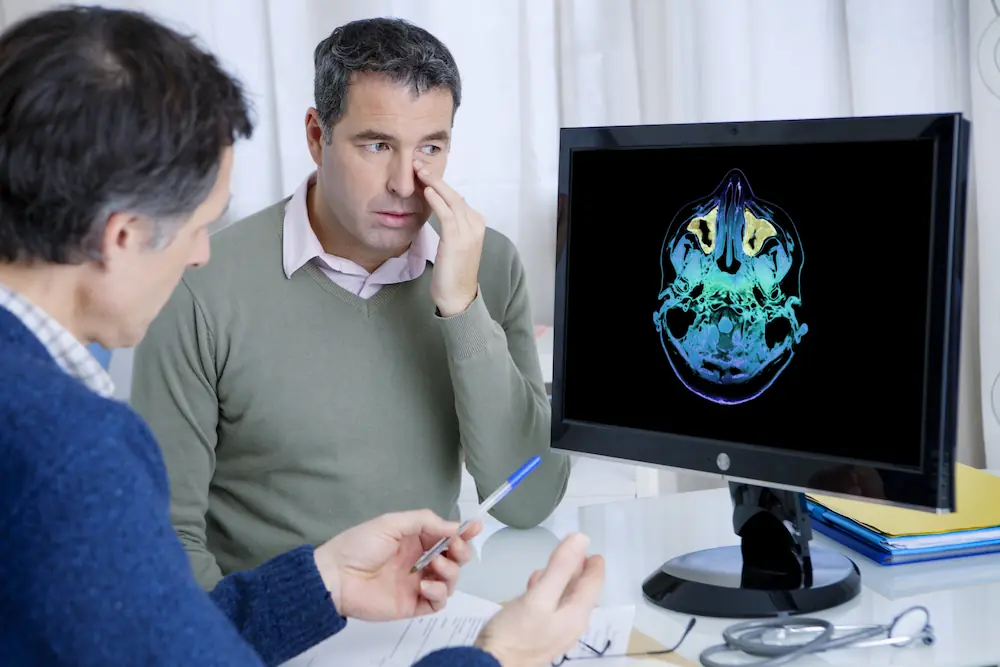 Man reviewing sinus xray with doctor