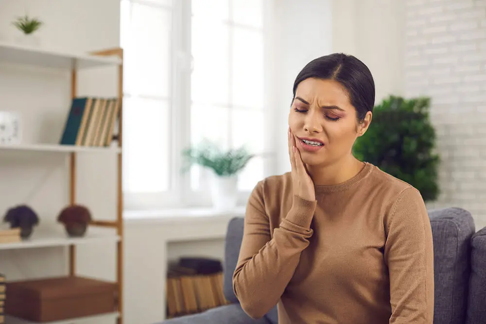 Woman holding jaw in pain